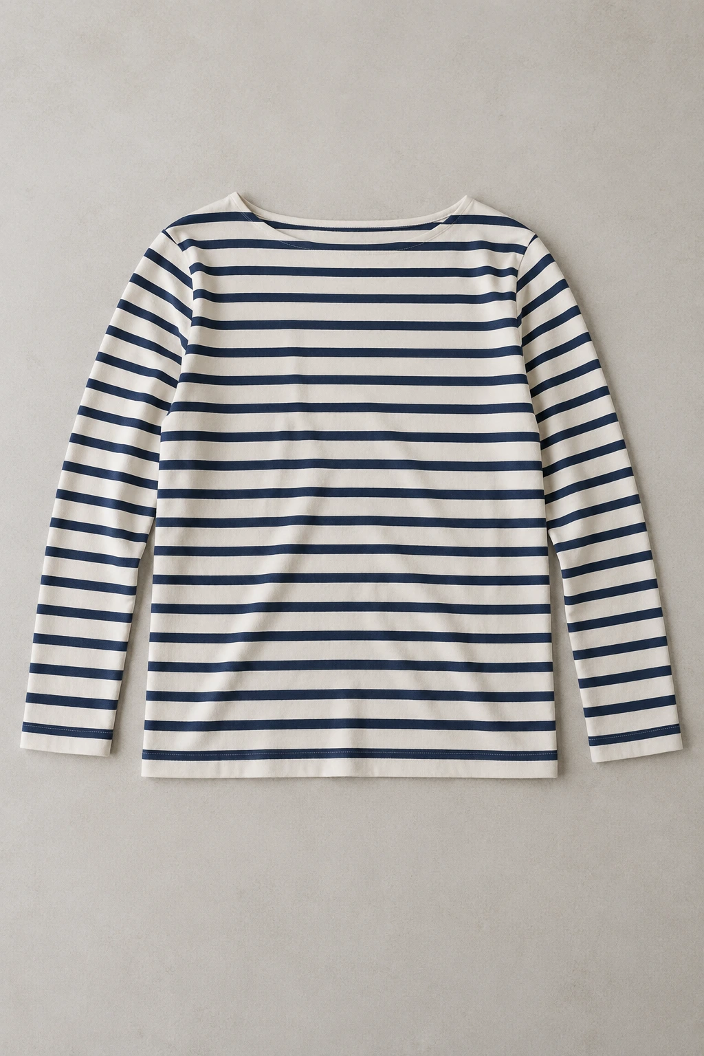 Ivory and navy striped long-sleeve top in a flat-lay photograph.